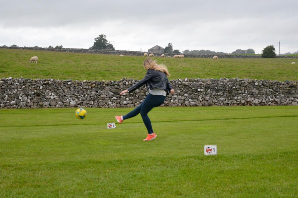 girl-kicking-football-put2golf-penrith-golf-football-stag-party-lake-district-elle-blonde-luxury-lifestyle-destination-blog